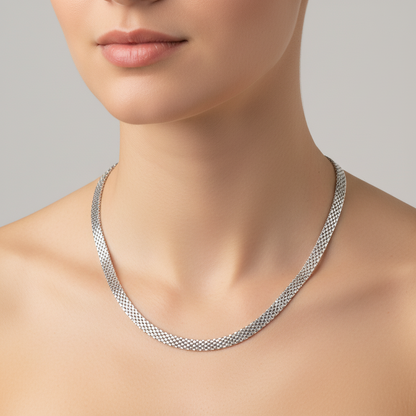 Silver necklace on a mannequin with a neutral background