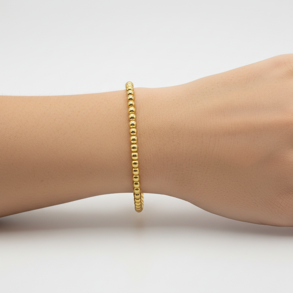 Gold bead bracelet on lady's wrist